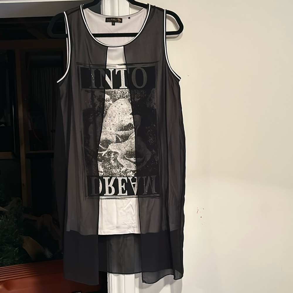 Beautiful tunic top with black sheer overlay. Lots of sparkle. In black & cream